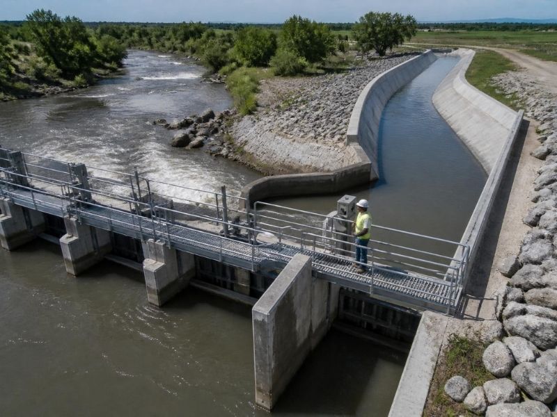 Civil engineer inspecting a diversion dam and concrete water channel near Frisco, Texas.